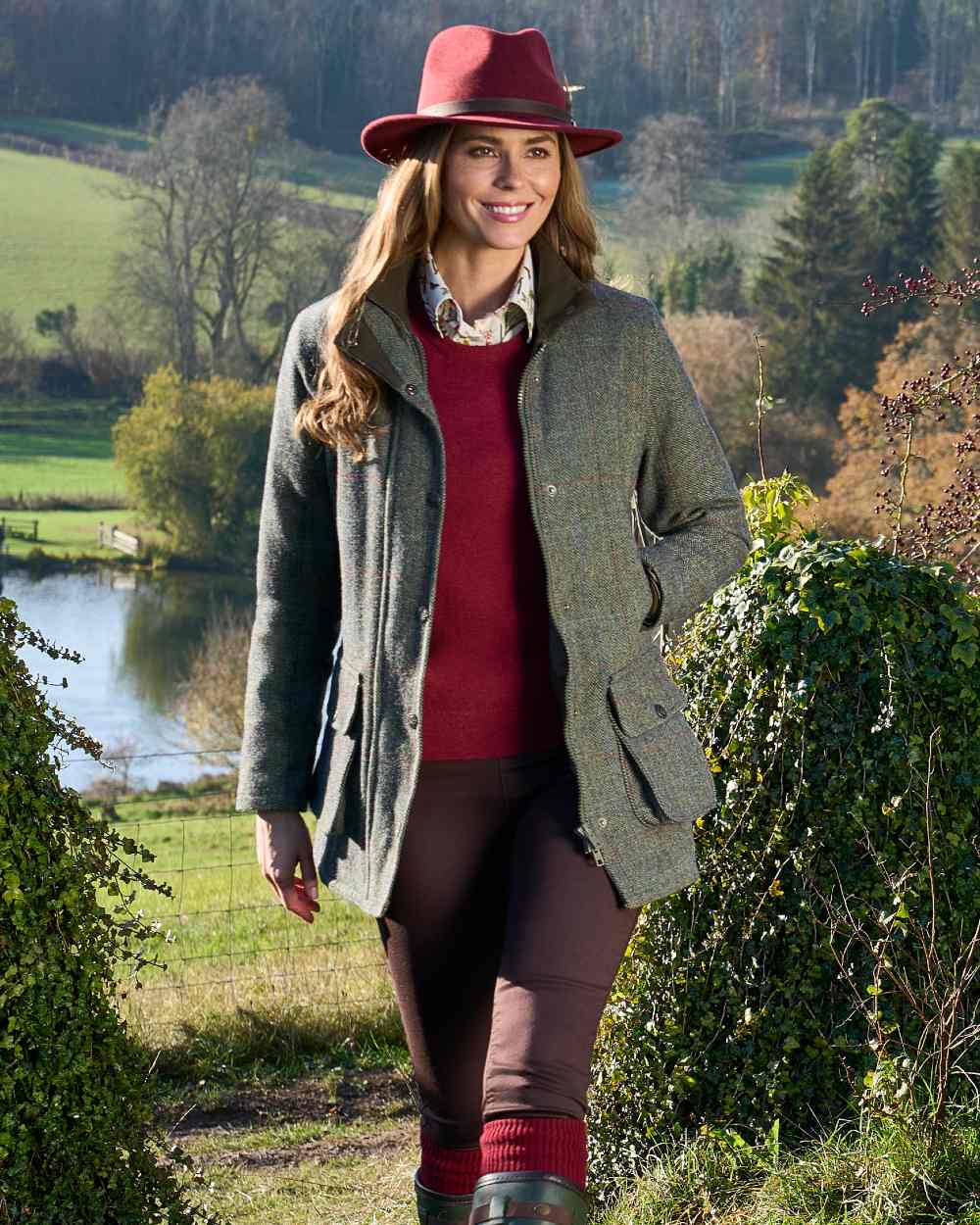Juniper coloured Alan Paine Rutland Ladies Waterproof Tweed Jacket on forest background 