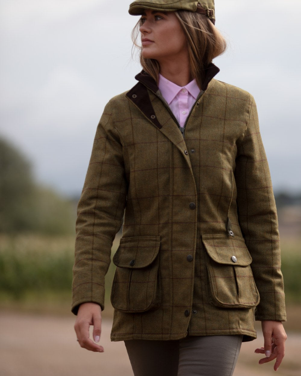 Lichen coloured Alan Paine Rutland Ladies Waterproof Tweed Jacket on blurry background 
