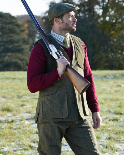 Oak coloured Alan Paine Rutland Tweed Shooting Waistcoat on forest background 