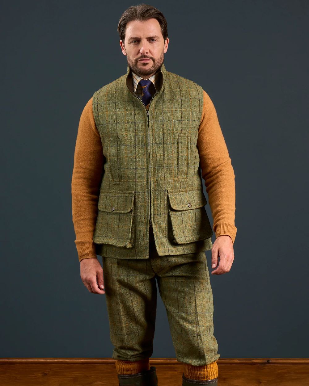 Dark Moss Coloured Alan Paine Rutland Tweed Waistcoat on indoor background 