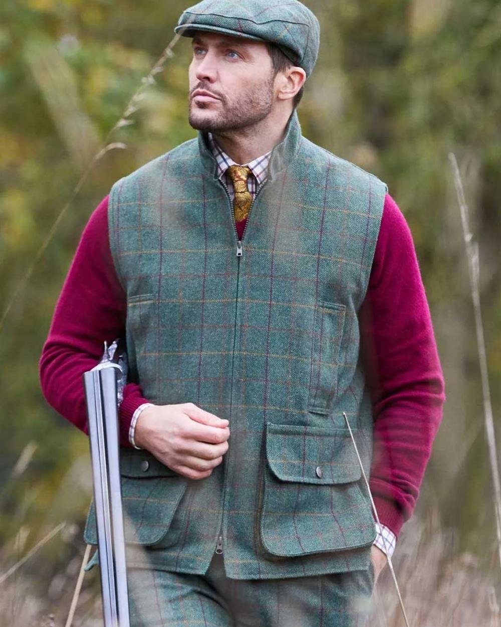 Fern coloured Alan Paine Rutland Tweed Waistcoat on forest background 