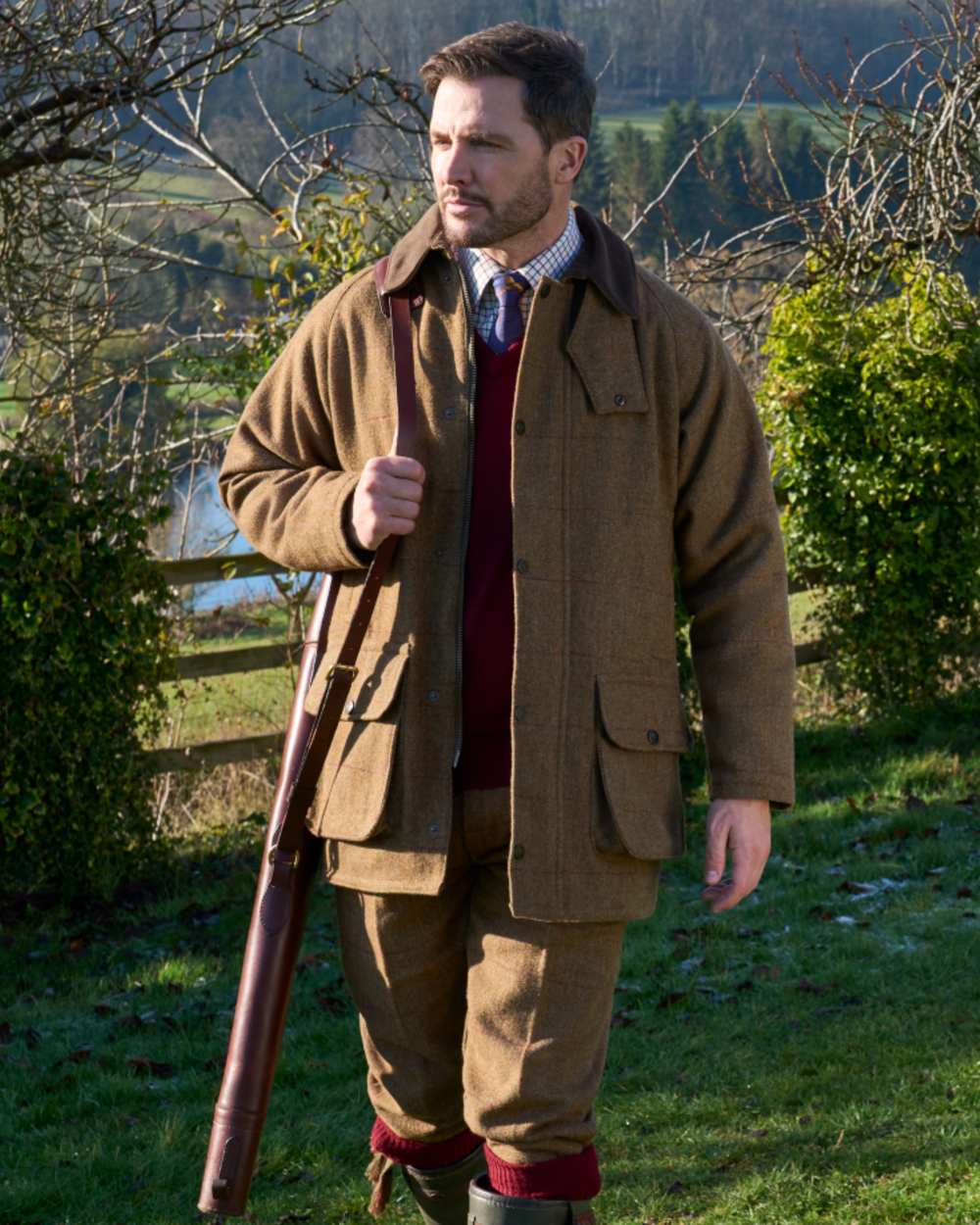 Birch coloured Alan Paine Rutland Waterproof Tweed Shooting Coat on forest background 