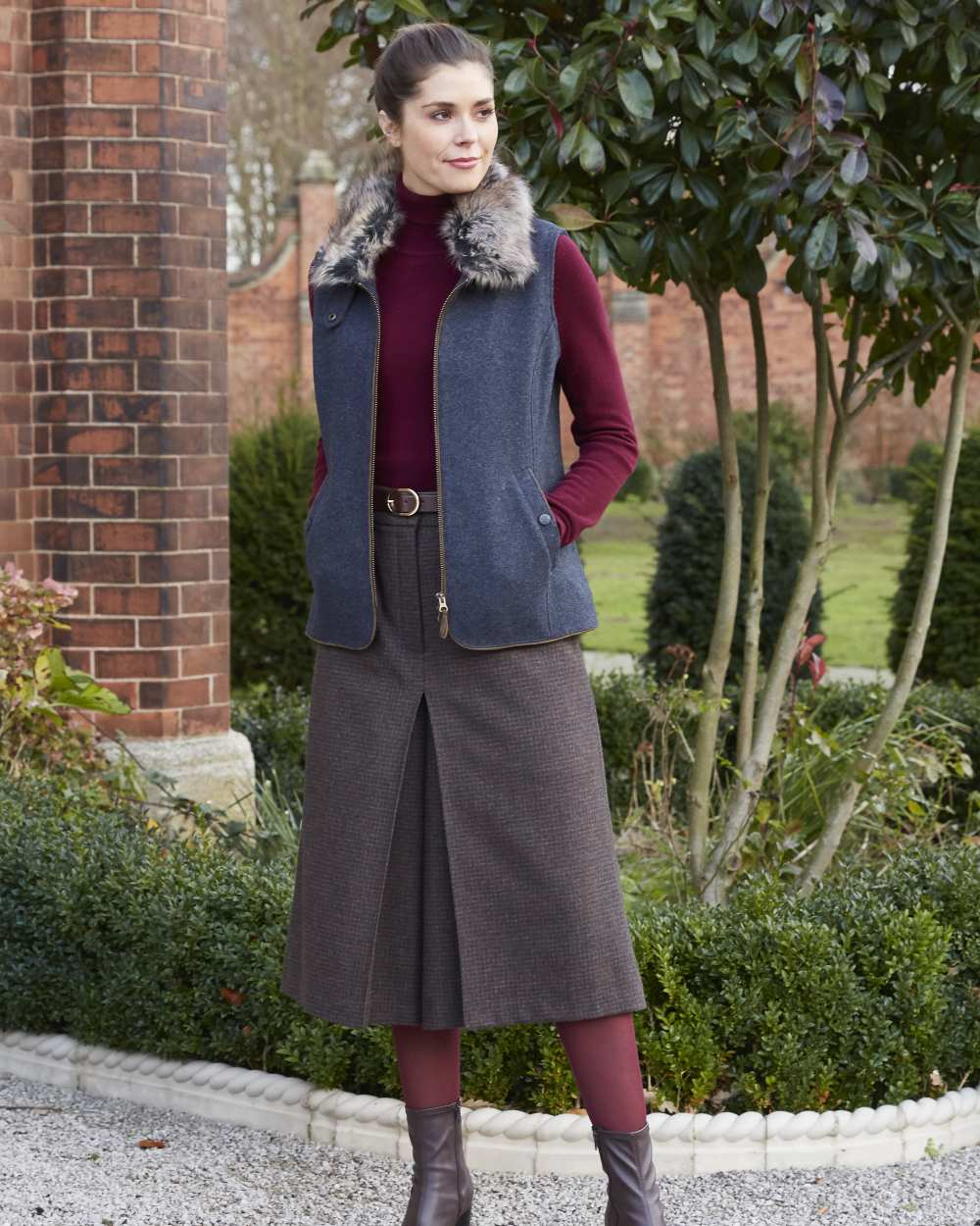 Blue coloured Alan Paine Surrey Ladies Tweed Gilet on yard background 