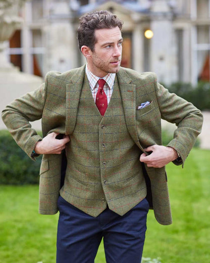 Meadow coloured Alan Paine Surrey Mens Tweed Lined Blazer on blurry house background 