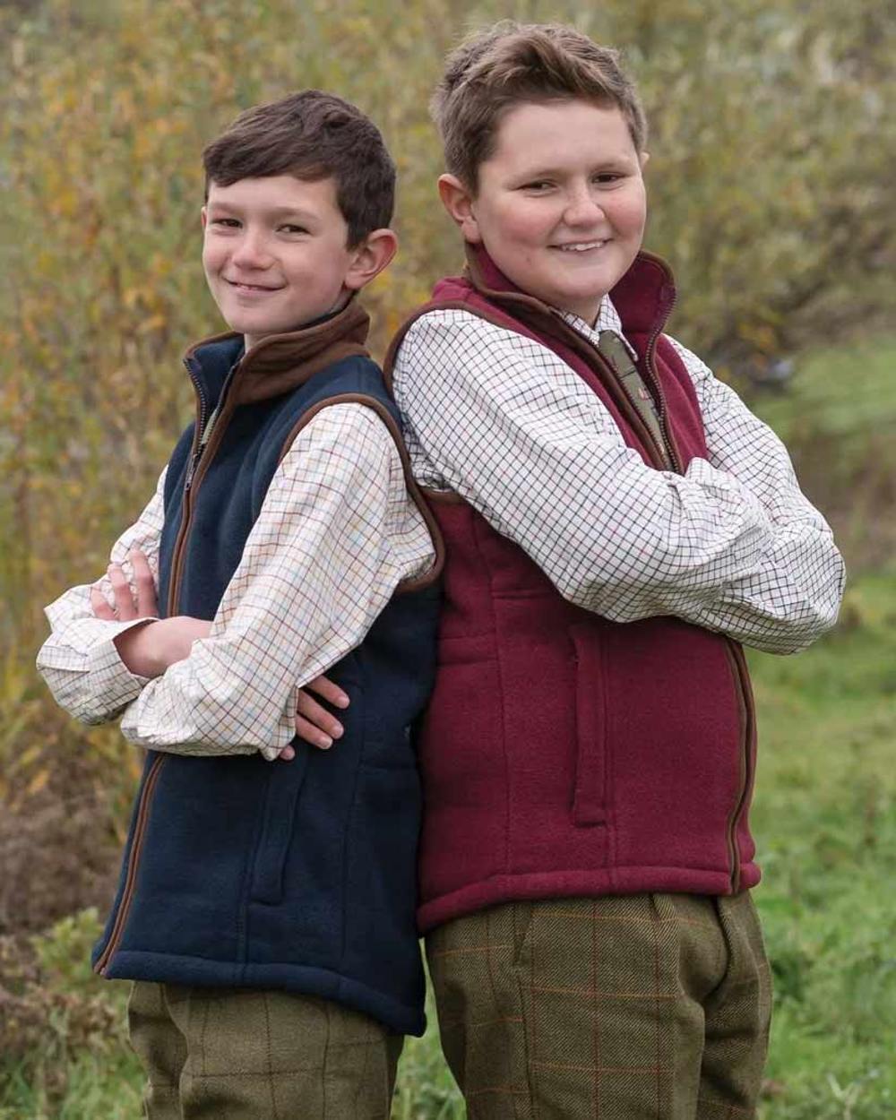 Dark Navy coloured Alan Paine Childrens Aylsham Fleece Gilet on field background 