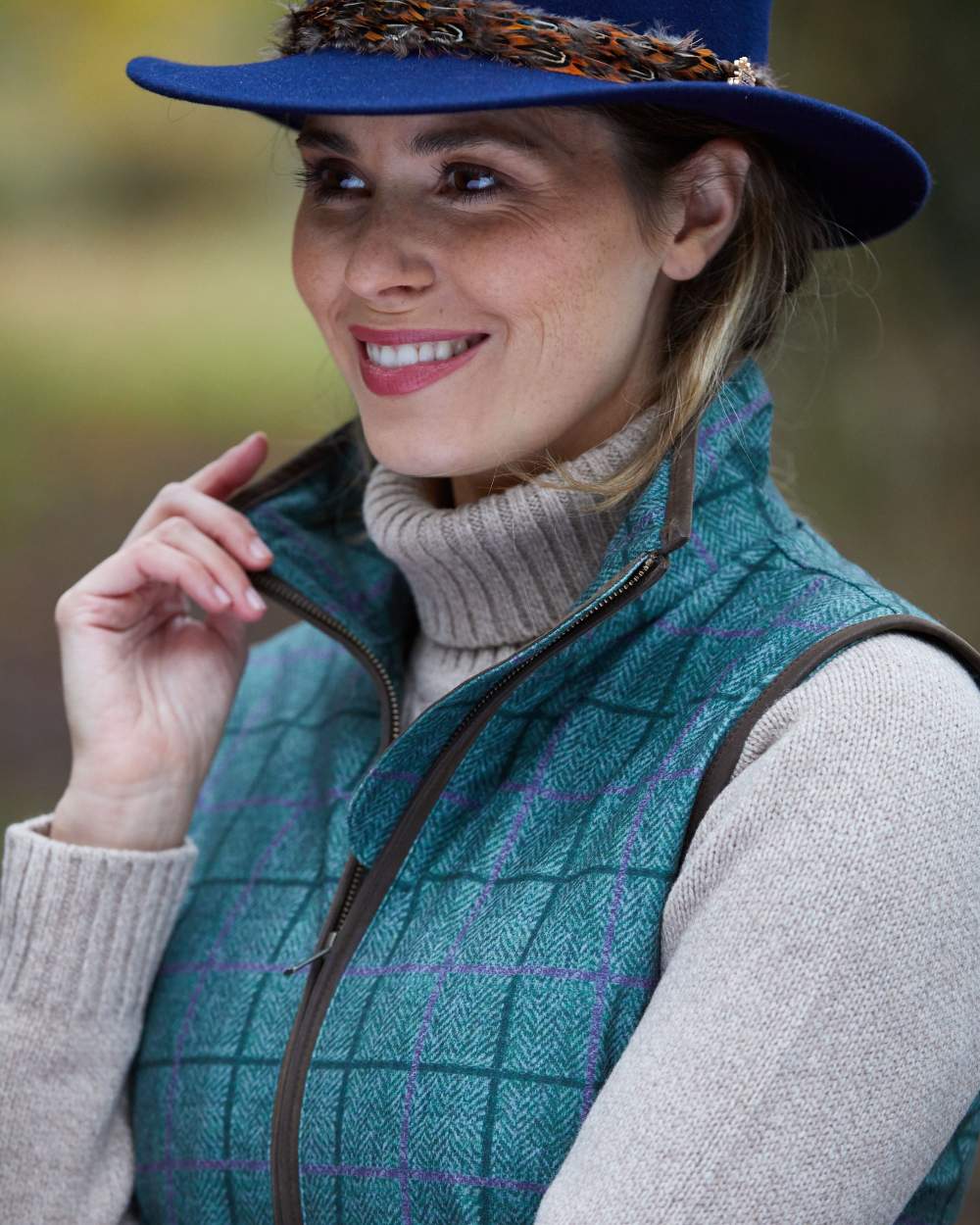 Seagrass coloured Alan Paine Womens Didsmere Gilet on blurry background 