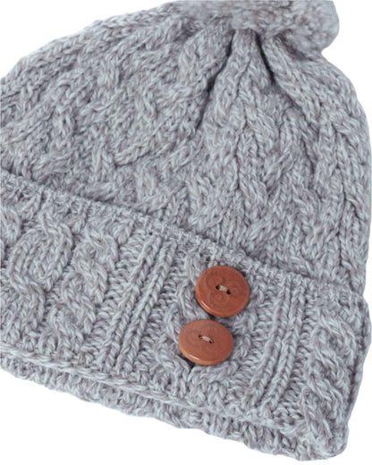 Beige Coloured Aran Chunky Knit Button Bobble Hat on white background 