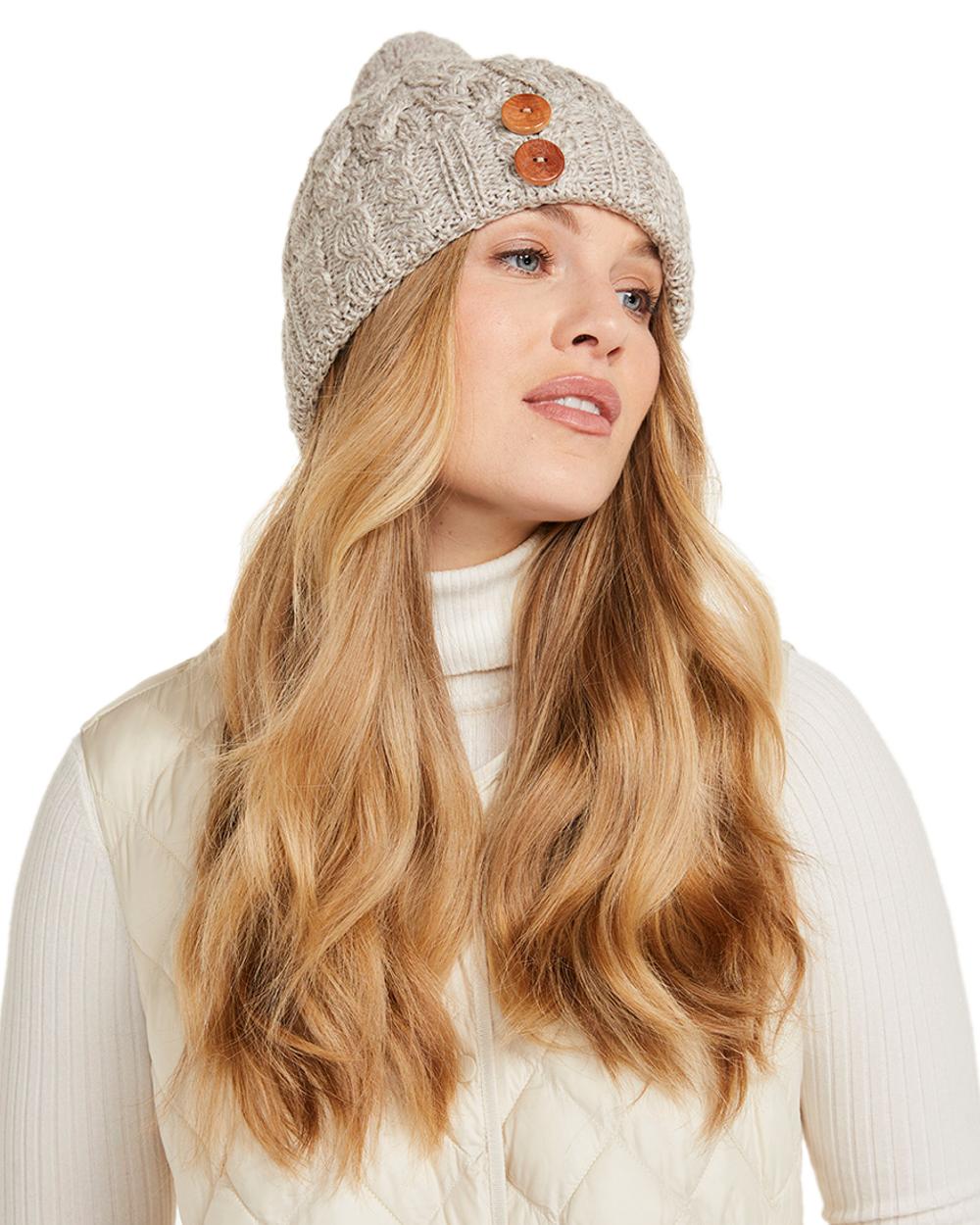 Beige Coloured Aran Chunky Knit Button Bobble Hat on white background 