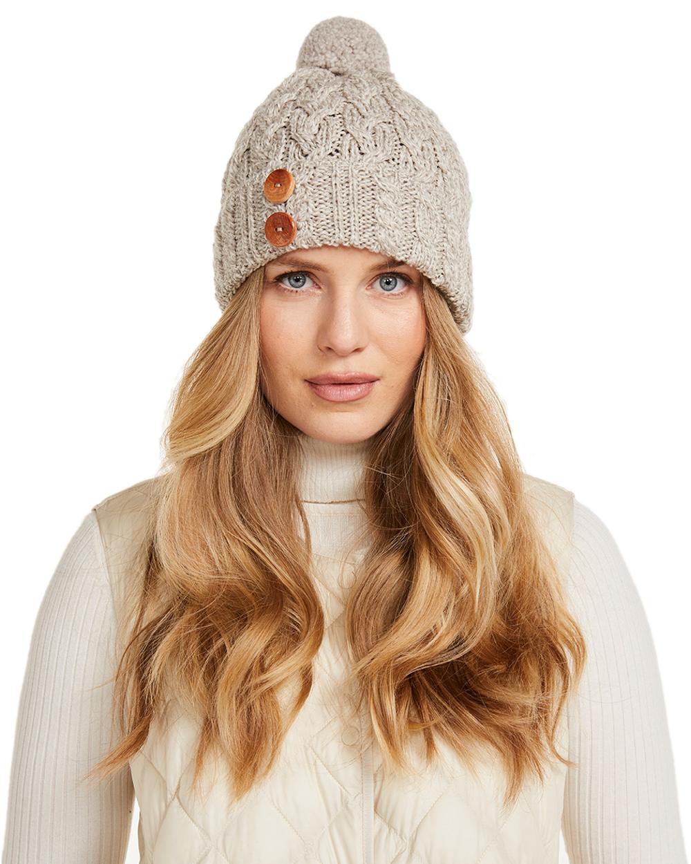 Beige Coloured Aran Chunky Knit Button Bobble Hat on white background 