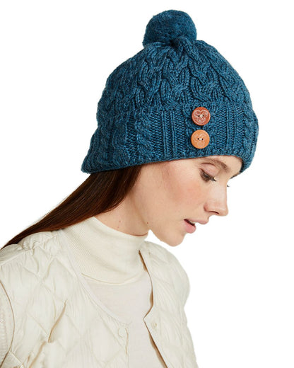 Teal Coloured Aran Chunky Knit Button Bobble Hat on white background 