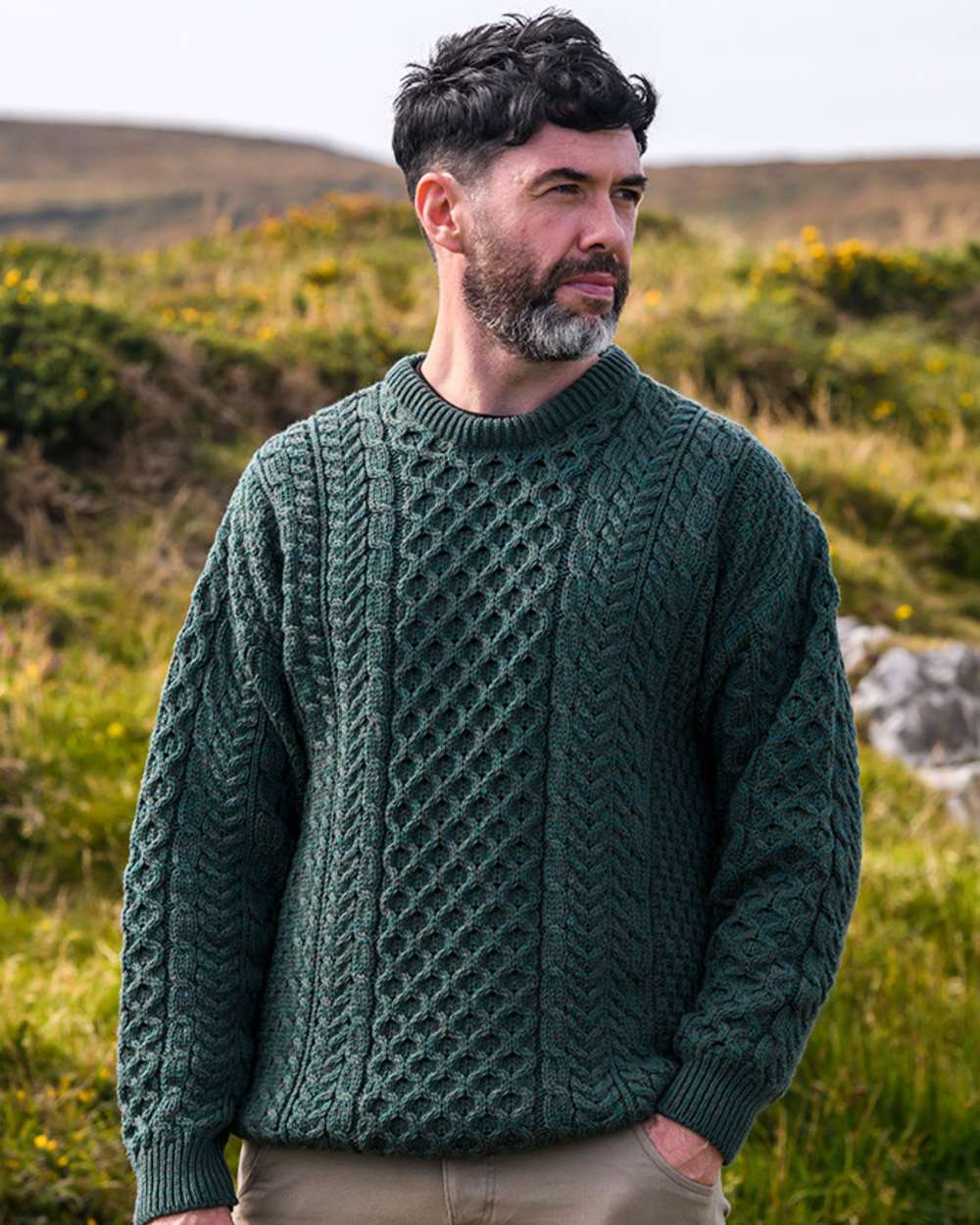 Deep Forest coloured Aran Mens Inishbofin Traditional Sweater on forest background 