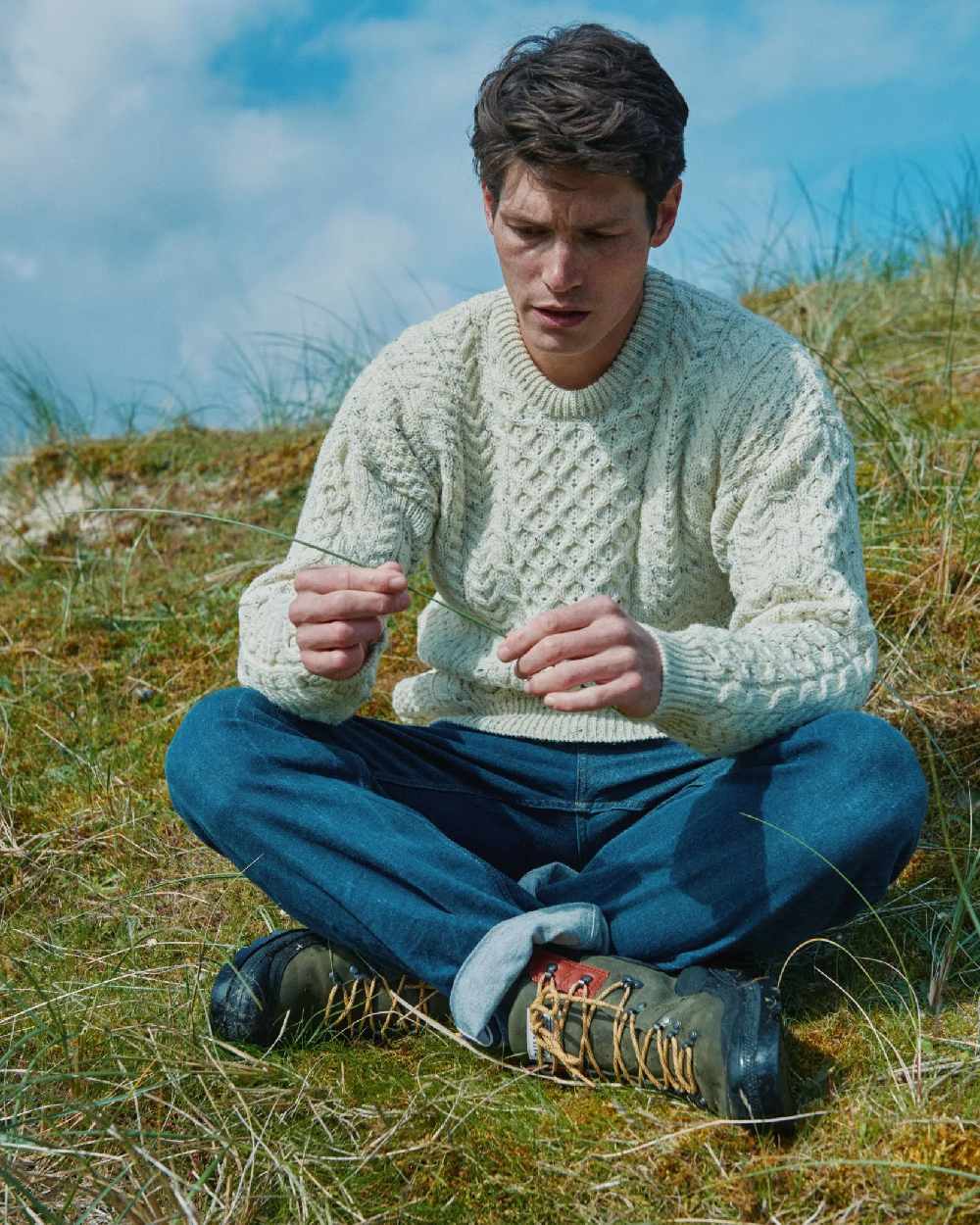 Flecked Cream coloured Aran Inishbofin Traditional Sweater on hillside background 