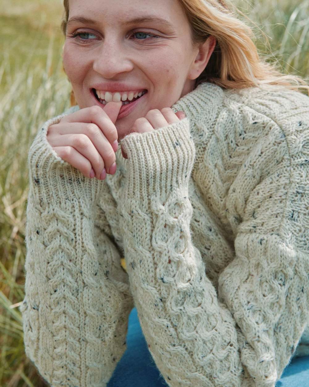 Flecked Cream coloured Aran Inishbofin Traditional Sweater on hillside background 