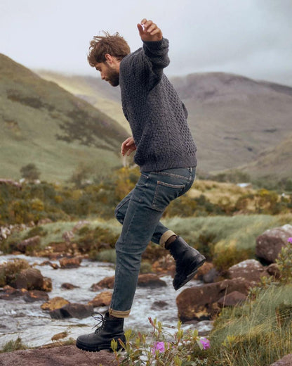 Charcoal Coloured Aran Inisheer Traditional Sweater on mountain background 