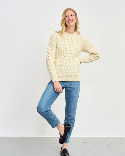 Cream Coloured Aran Inisheer Traditional Sweater on grey wall background 