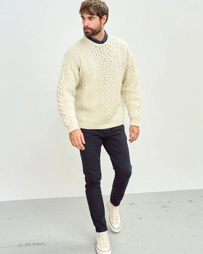 Cream Coloured Aran Inisheer Traditional Sweater on grey wall background 