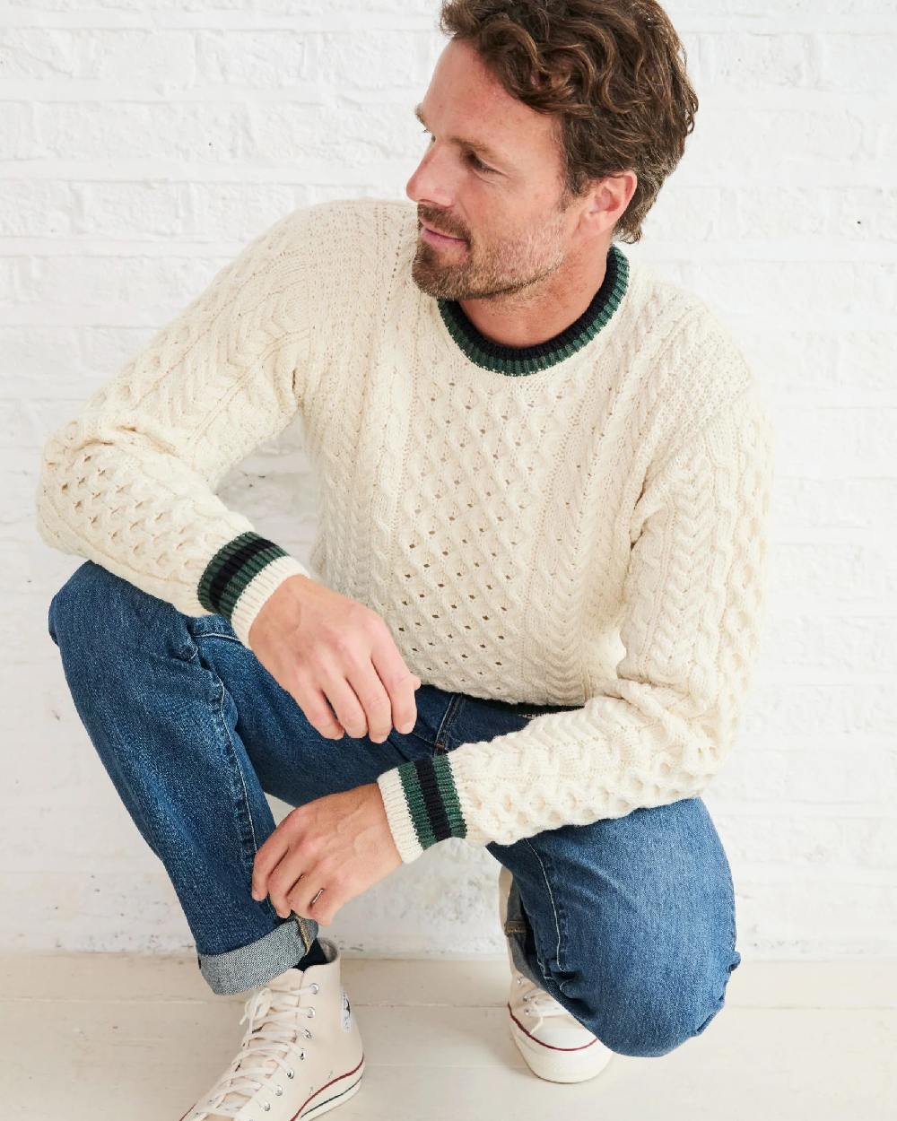 Cream Coloured Aran Mens Inishbeg Stripe Crewneck Merino Sweater on indoor background 