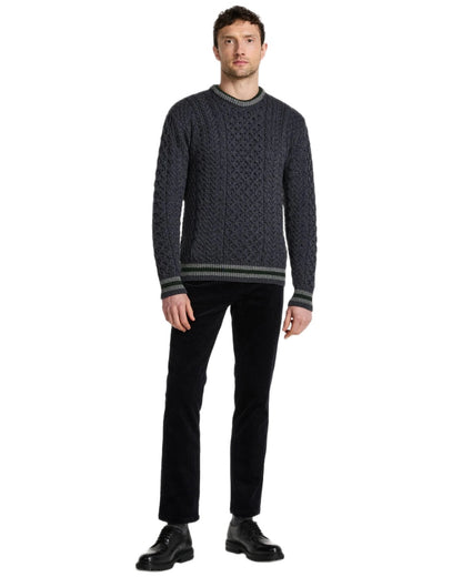 Dark Grey Coloured Aran Mens Inishbeg Stripe Crewneck Merino Sweater on white background 