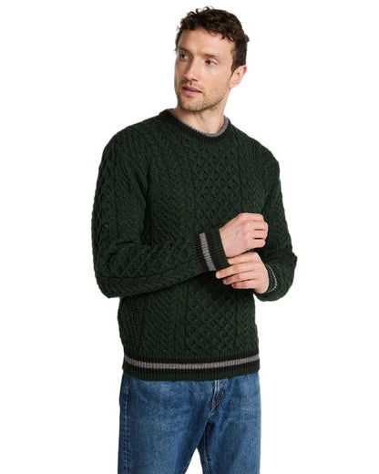 Green Coloured Aran Mens Inishbeg Stripe Crewneck Merino Sweater on white background 