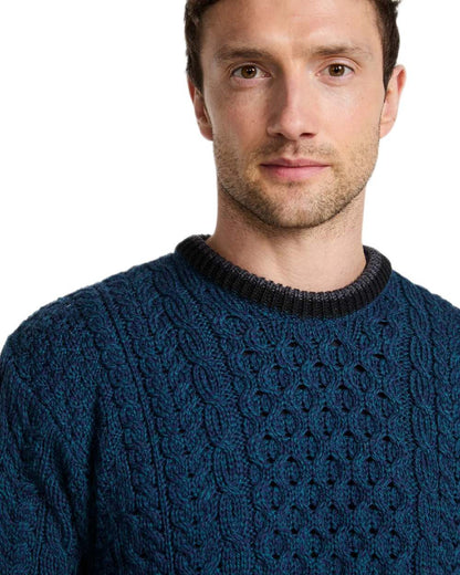 Teal Coloured Aran Mens Inishbeg Stripe Crewneck Merino Sweater on white background 