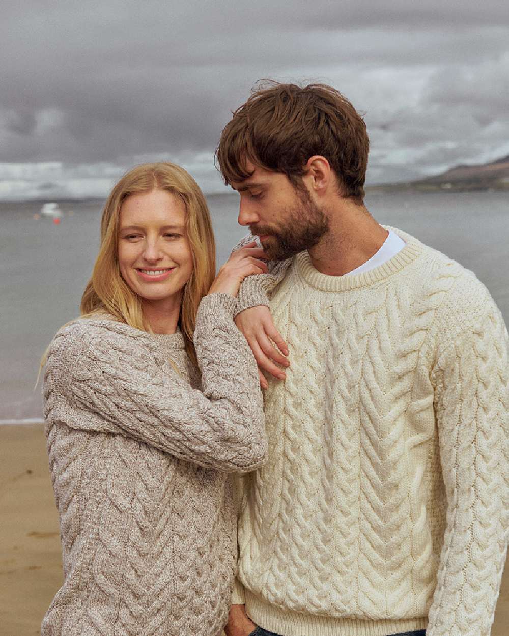 Cream Coloured Aran Merino Wool Crew Neck Jumper on sea background 