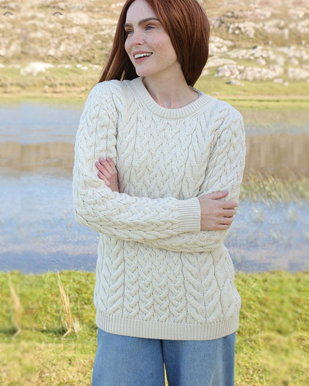 Cream Coloured Aran Merino Wool Crew Neck Jumper on pond background 