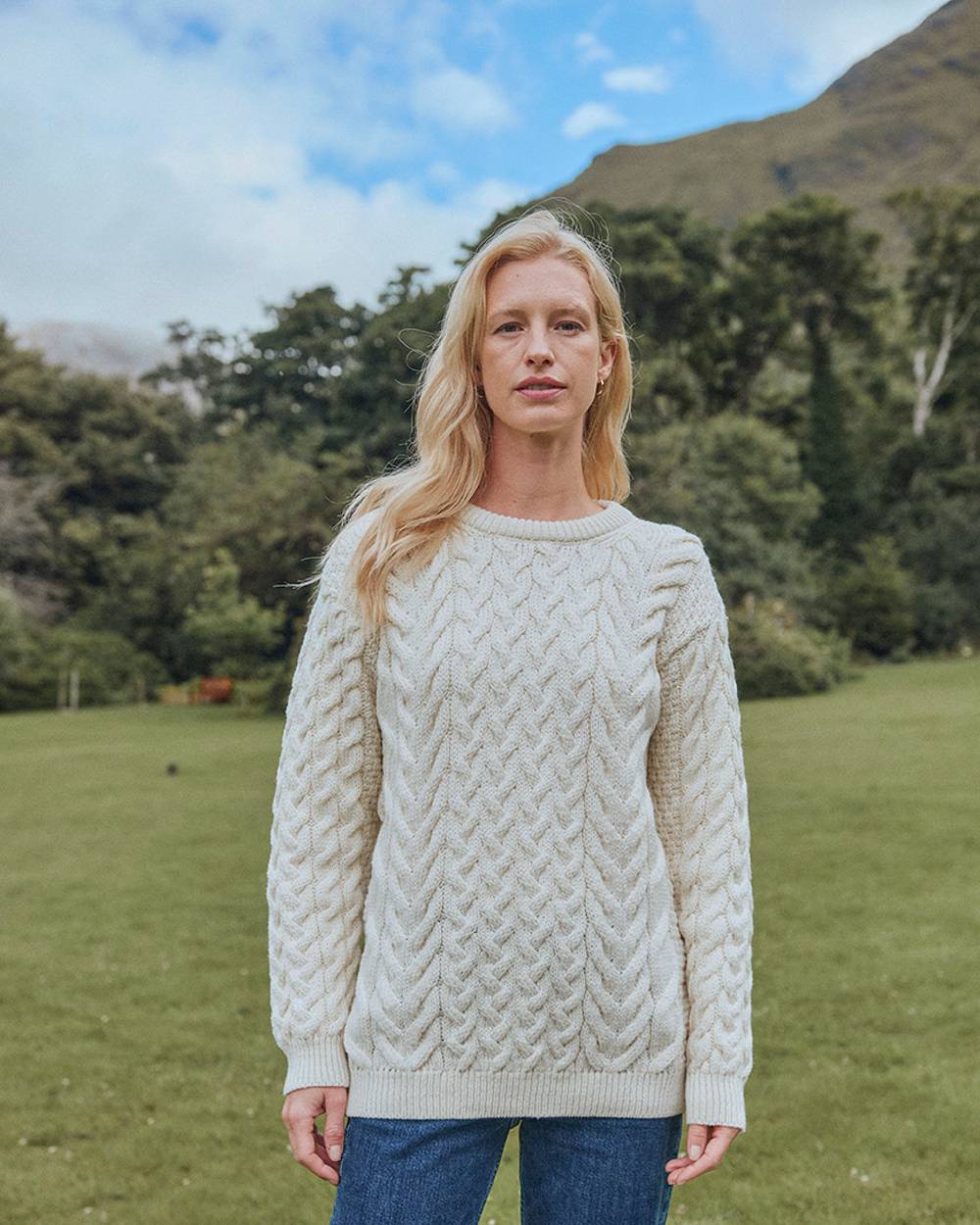 Cream Coloured Aran Merino Wool Crew Neck Jumper on mountain background 