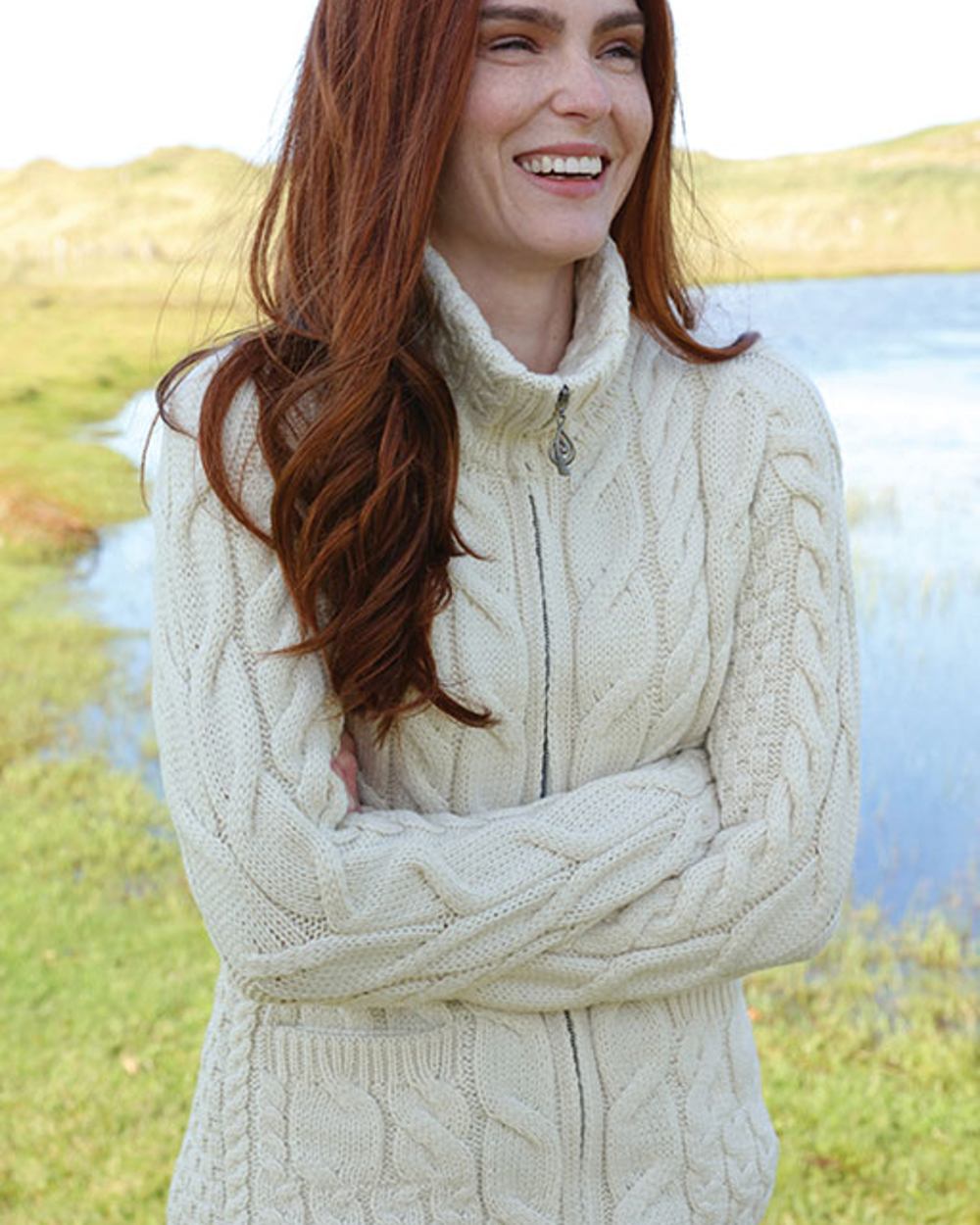 Cream Coloured Aran Merino Wool Full Zip Cardigan on lake background 