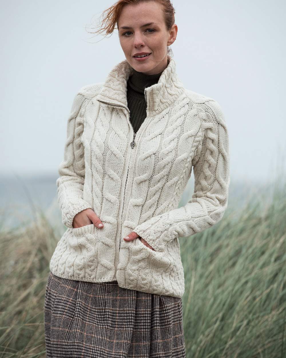 Cream Coloured Aran Merino Wool Full Zip Cardigan on grass background 