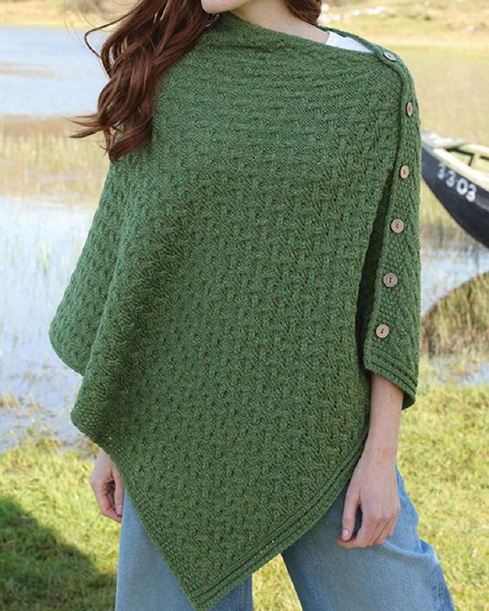 Sage Green Coloured Aran Merino Wool Knit Button Poncho on lake background 