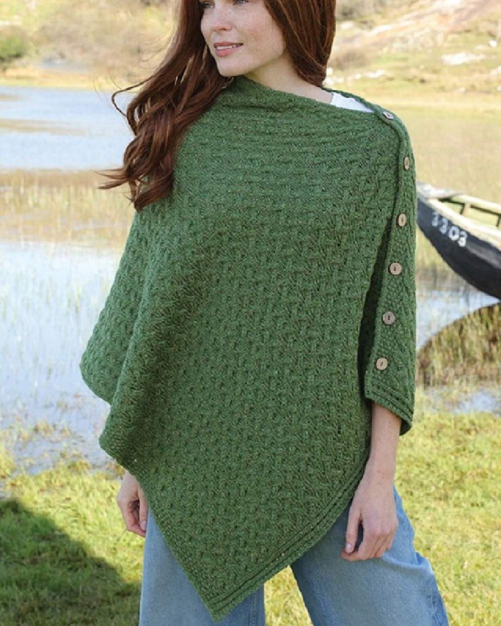 Sage Green Coloured Aran Merino Wool Knit Button Poncho on pond background 