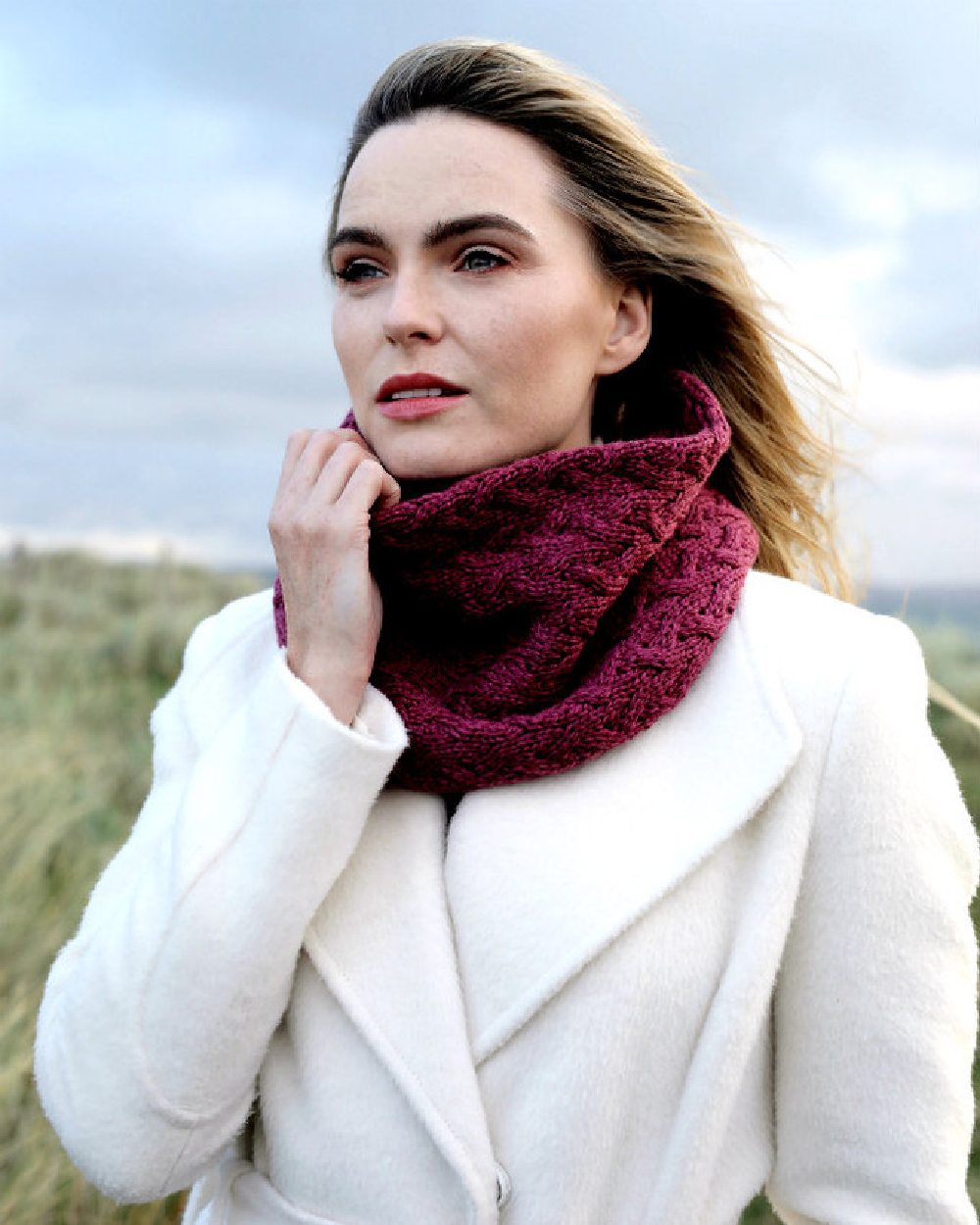 Jam coloured Aran Merino Wool Snood on blurry background 