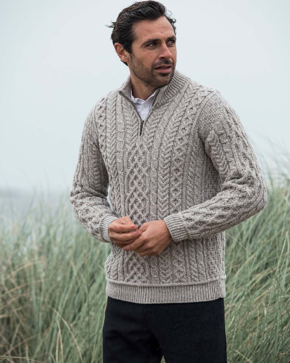 Oat Coloured Aran Supersoft Merino 1/2 Zip Jumper on grass background 