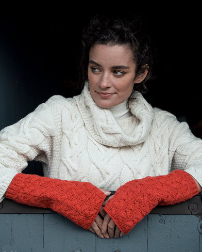 Coral Coloured Aran Supersoft Merino Fingerless Gloves on window background 