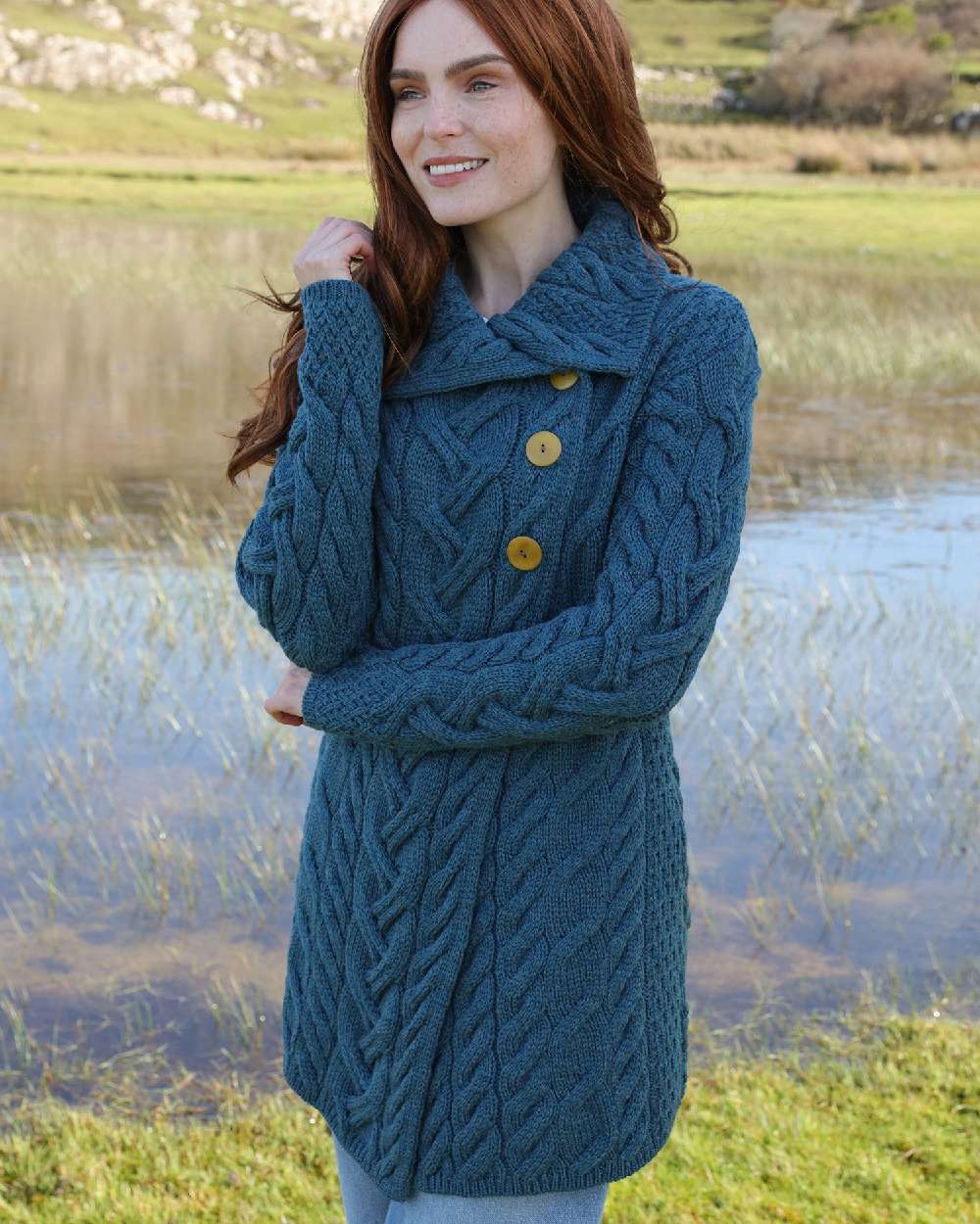 Teal Coloured Aran Supersoft Merino Wool Long Cardigan on pond background 