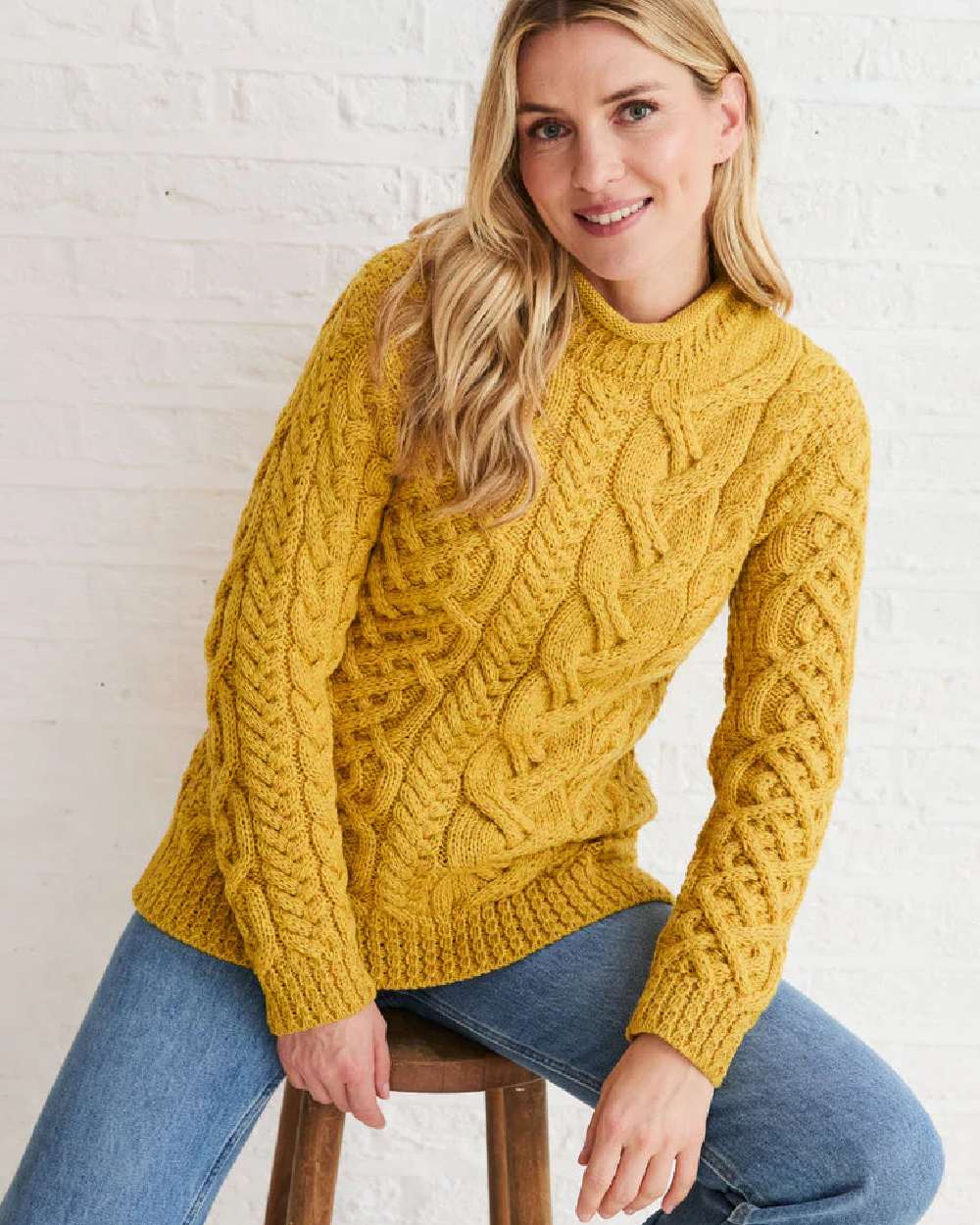 Yellow Coloured Aran Womens Calla Aysmmetrical Pattern Sweater on indoor background 