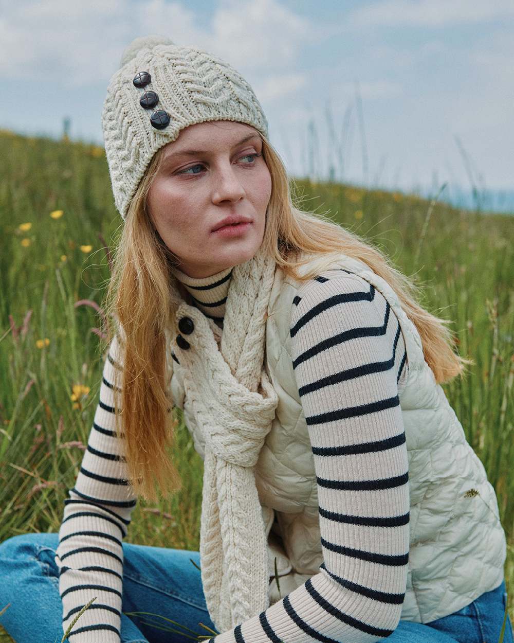 Cream Coloured Aran Womens Cong Hat With Pom Pom on outdoor background 