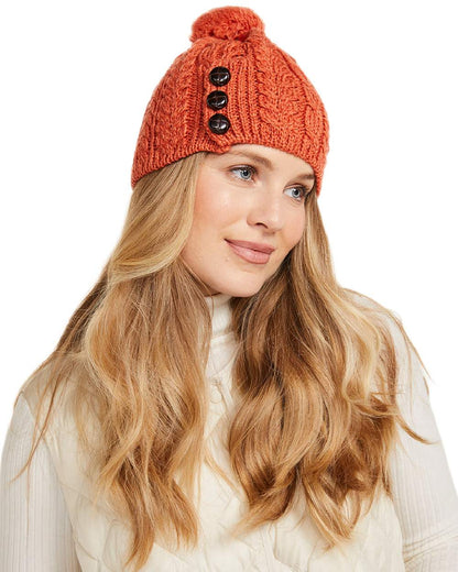 Red Orange Coloured Aran Womens Cong Hat With Pom Pom on white background 