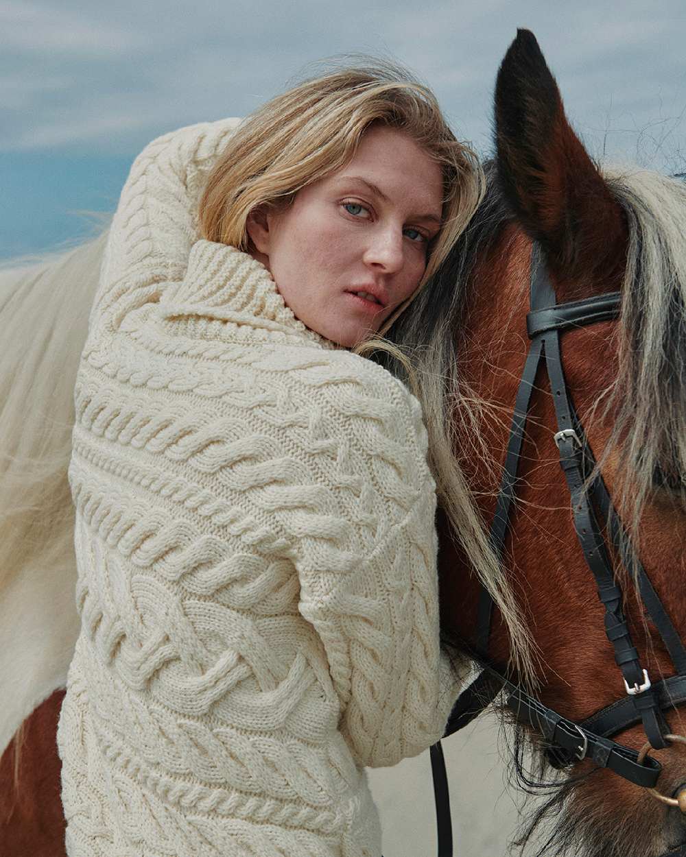 Cream Coloured Aran Womens Derreen Horizontal Cable Sweater on outdoor background 