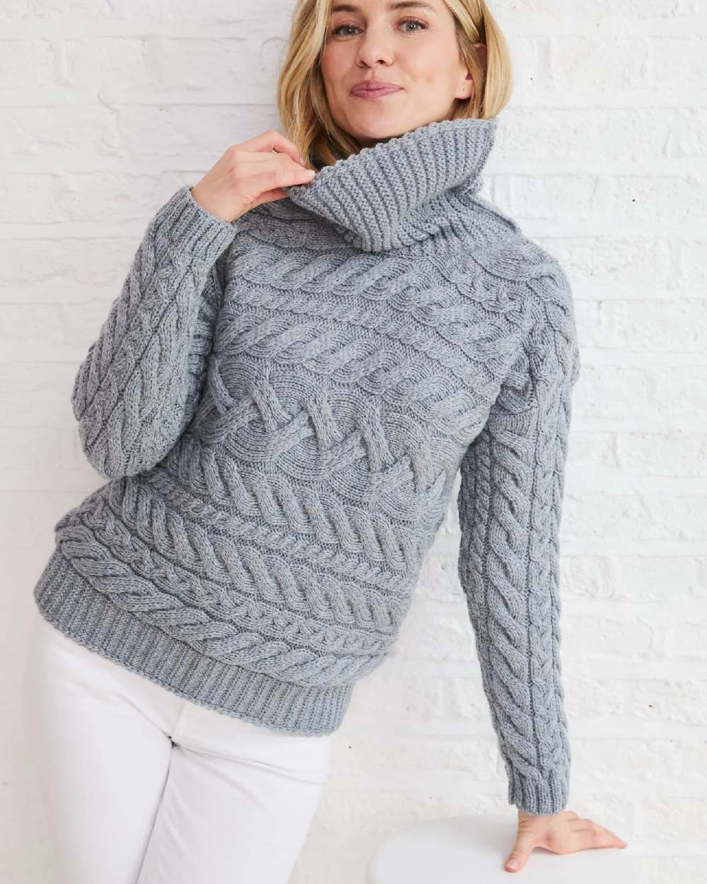 Denim Coloured Aran Womens Derreen Horizontal Cable Sweater on outdoor background 