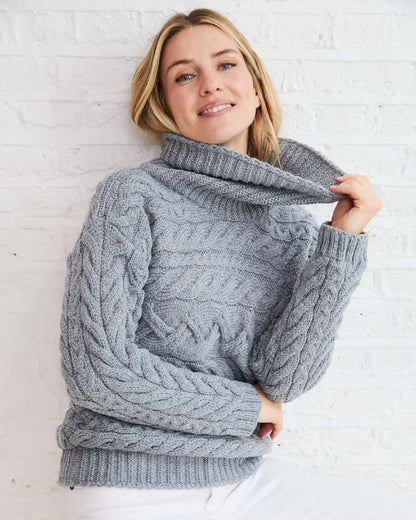 Denim Coloured Aran Womens Derreen Horizontal Cable Sweater on indoor background 