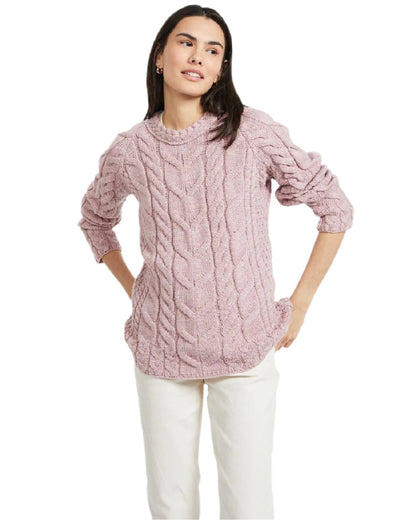 Pink Coloured Aran Womens Listowel Cabled Sweater on curtain background 