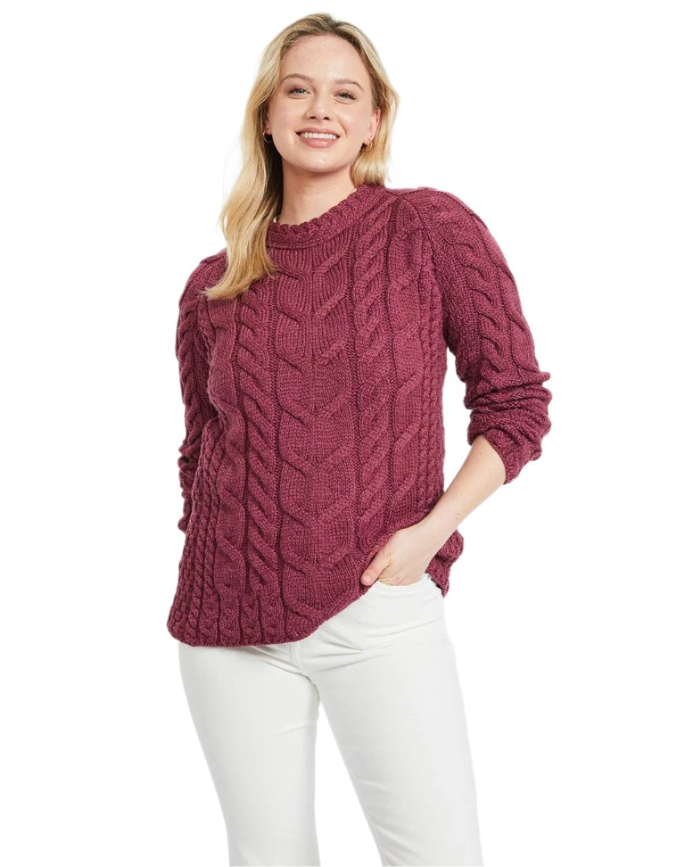 Raspberry Coloured Aran Womens Listowel Cabled Sweater on curtain background 