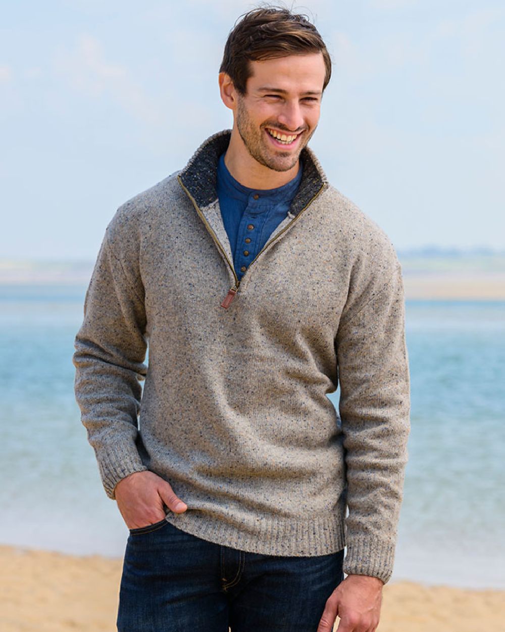 Beige Coloured Aran Wool Zip Neck Sweater on sea background 