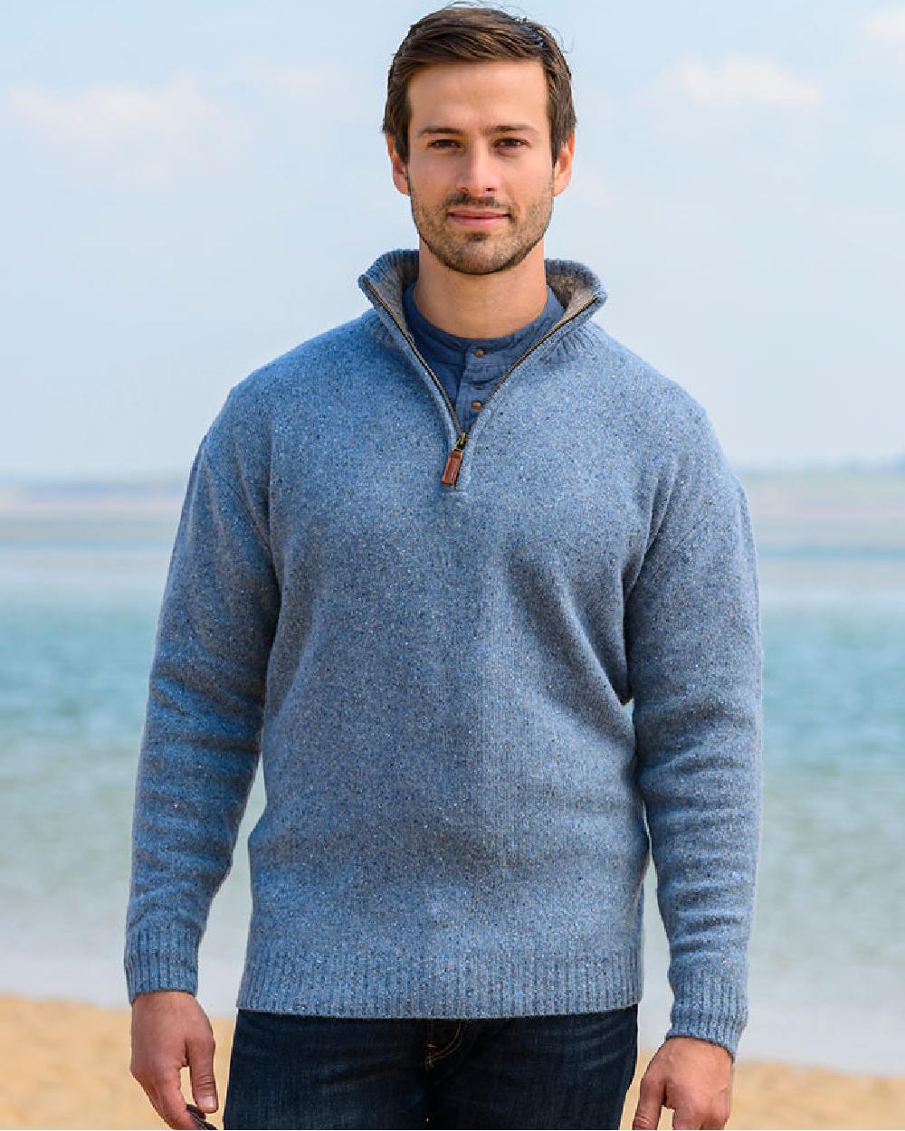 Blue Coloured Aran Wool Zip Neck Sweater on sea background 