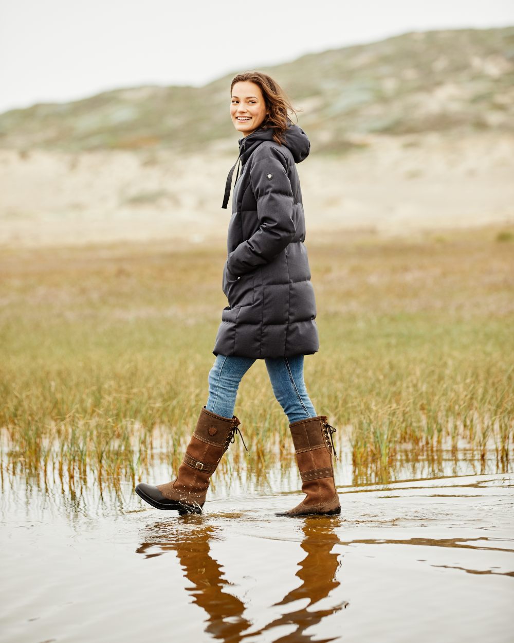 Java coloured Ariat Langdale Waterproof Boots on field background 