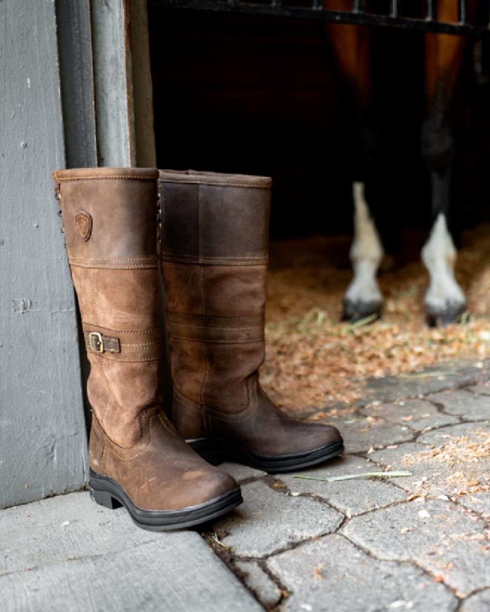 Java coloured Ariat Langdale Waterproof Boots on stable background 