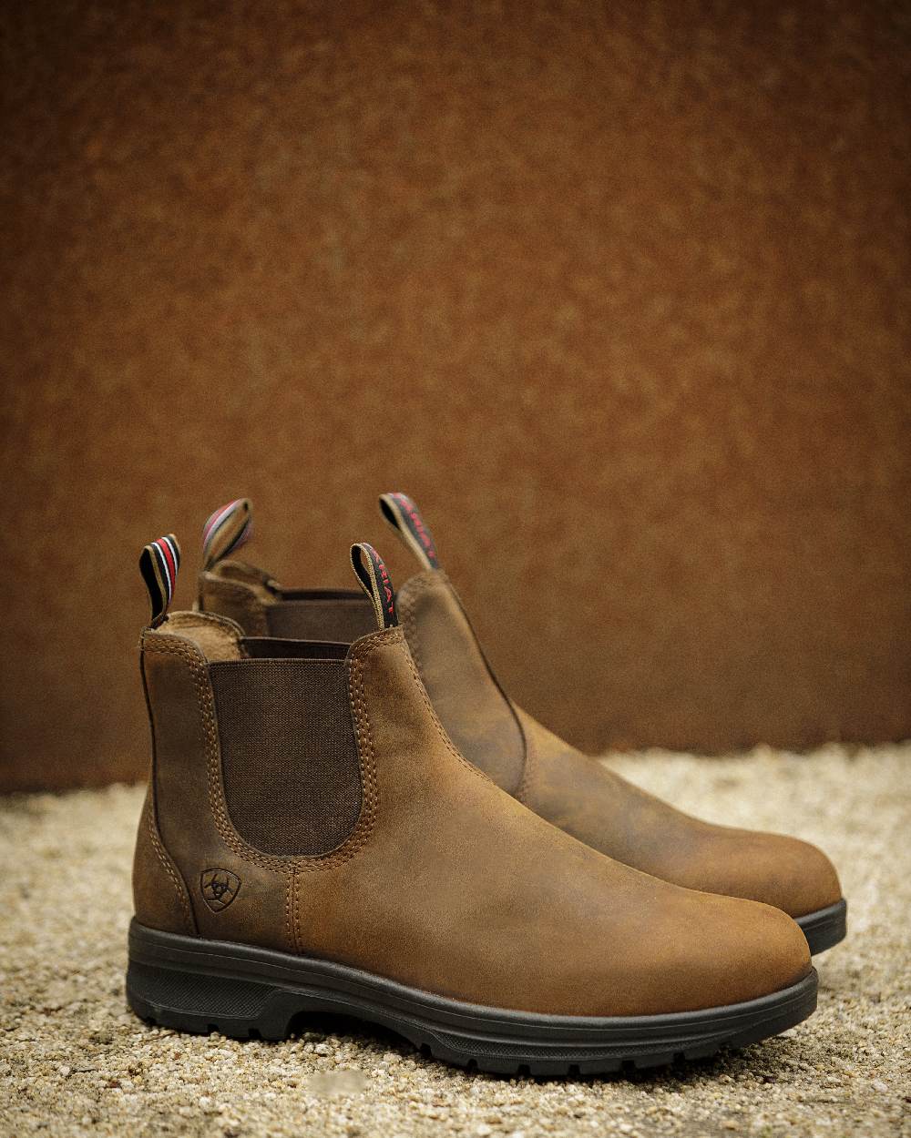 Distressed Copper coloured Ariat Mens Cooper Chelsea Boots on wall background 