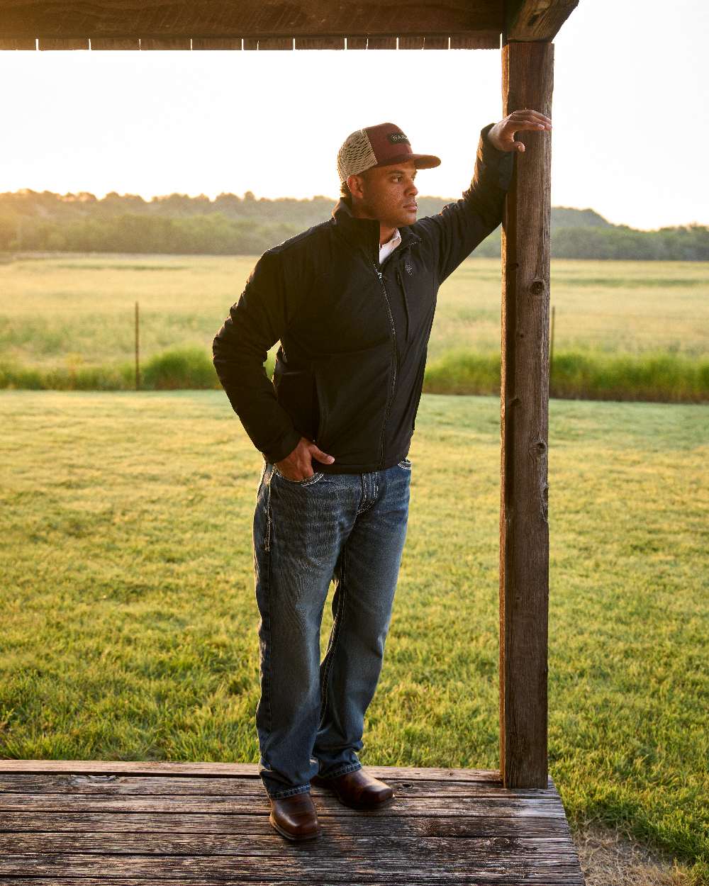 Barn Brown Coloured Ariat Mens Midtown Rambler Western Boots on countryside background 