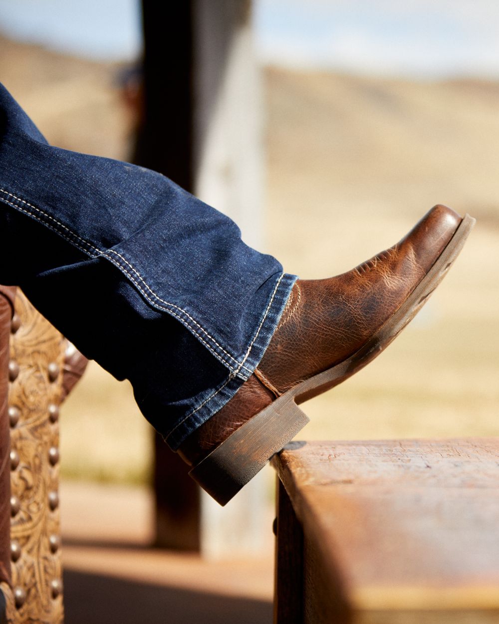 Wicker Coloured Ariat Mens Rambler Western Boots on blurry background 